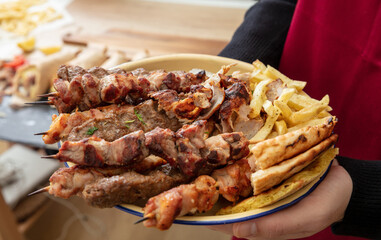 Grill meat skewer, Souvlaki chicken and pork, kebab doner served in a plate, close up. Greek food