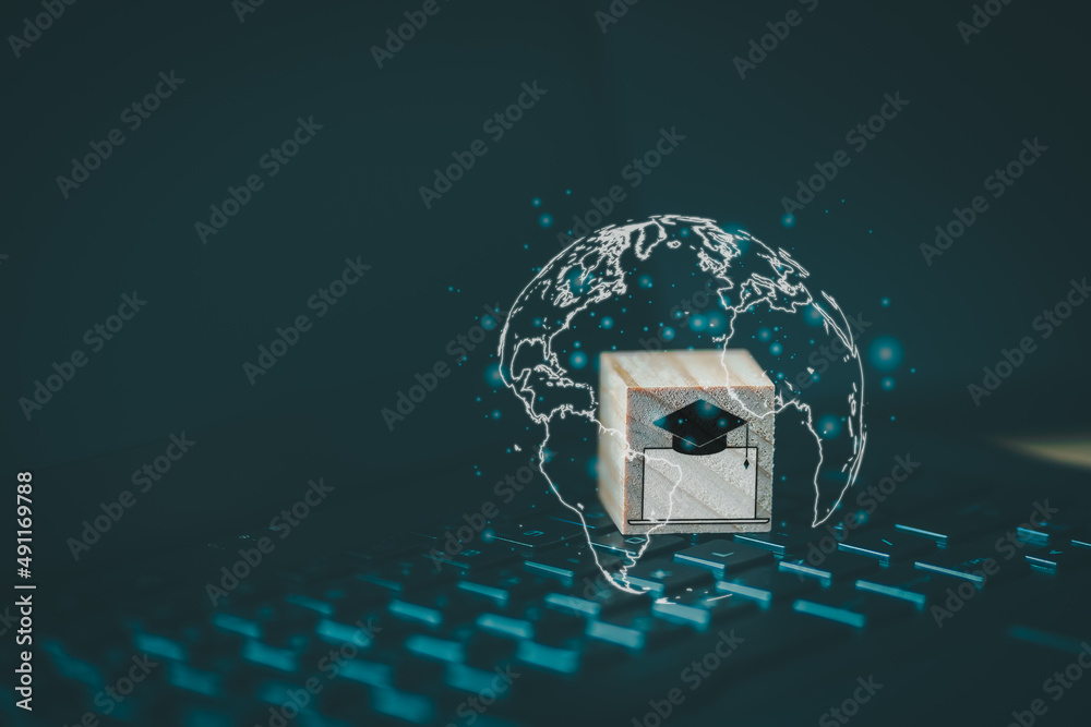 Aufkleber Graduation cap icon with computer laptop icon on wooden cube block  which is placed on a laptop. Concept of online learning for students