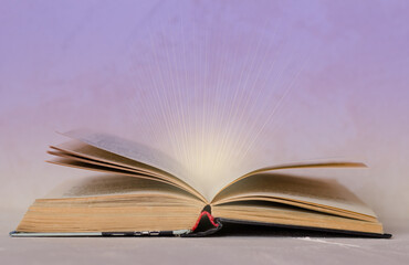 rays of light from an open book are a symbol of new knowledge . Back to school. Copy Space. Education background.