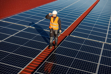 A handyman preparing to maintain solar panels on the rooftop.