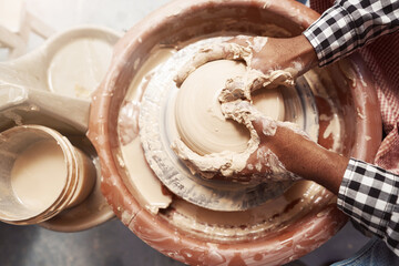 Experienced male potter working on pottery wheel
