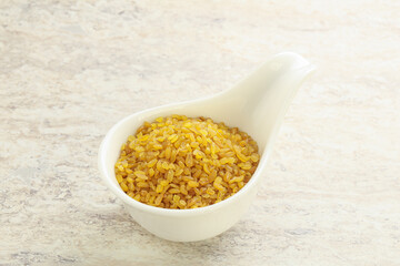 Raw bulgur in the bowl