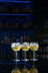 line of yellow refreshing cocktails on a bar desk
