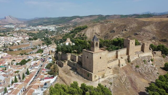 Aerial view of medieval Moorish castle of Alcazaba of Antequera on background with cityscape on sunny fall day, Malaga, Spain. High quality 4k footage