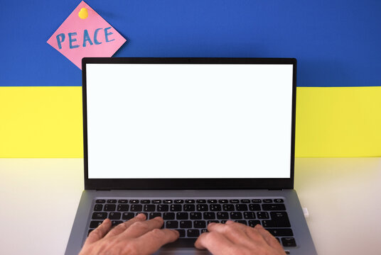 Flag of Ukraine on the background and wide digital screen of laptop for text or message. War with Russia. Cyber attack, sanctions, economic collapse. Message for world peace - Powered by Adobe