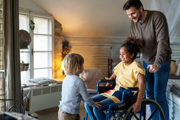 Happy multiethnic family. Smiling little girl with disability in wheelchair