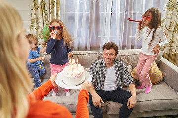 Obraz na płótnie Canvas Young family celebrating birthday and having fun