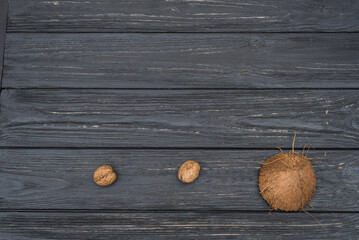 Obraz na płótnie Canvas Coconut and walnuts on wooden table