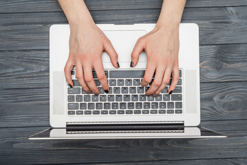 Fototapeta na wymiar Female hands typing on laptop