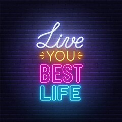 Fototapeta na wymiar Live You Best Life neon lettering on brick wall background.