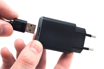 The man's hands hold the USB cable to connect to the adapter. USB cable on white background
