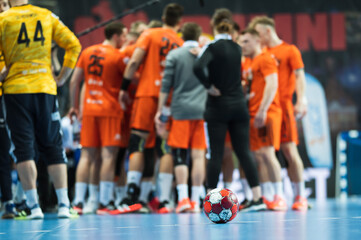 The ball on the court during a break of the handball match.