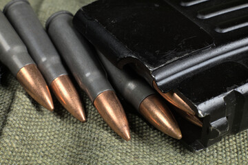Ak-47 ammunition being loaded to magazine, military canvas background