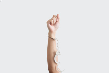 Hand rising up with unchained handcuff, isolated on white background