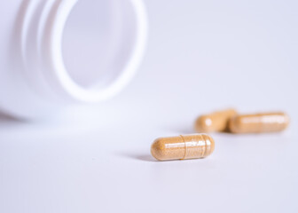 Pill spilling out of a bottle blurred background, Medicine capsule for health