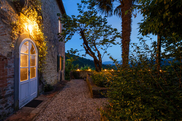 House or cottage at sunset with a beautiful garden in Tuscany. The place is romantic and makes you...
