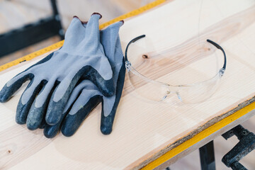 protective gloves and glasses for working with wood on the planing machine - obrazy, fototapety, plakaty