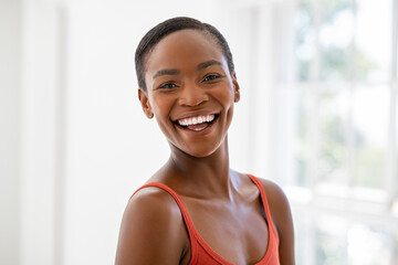 Beautiful African woman laughing and looking at camera