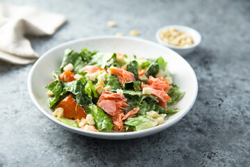 Traditional Caesar salad with salmon