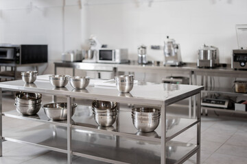 Professional restaurant kitchen with kitchen equipment and stainless steel tables. Interior with no...