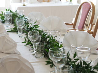 Wedding table setting with green garland