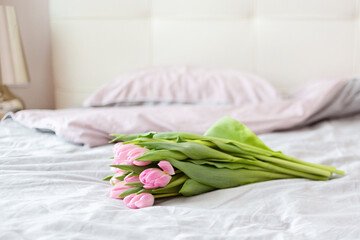 Bouquet on the bed in bedroom