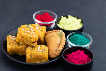 Indian Mawa Gujia Also Called Gujiya, Pirukiya, Pirukia, Pedakiya, Karanji, Basundi Gughra And Sindhi Mithai Sev Badam Halwa Burfi Barfee Or Barfi Served With Gulal Holi Colored Powder Gulal Abeer