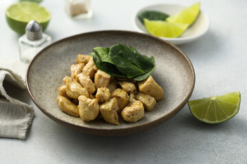 Baked chicken meat with spinach and lime