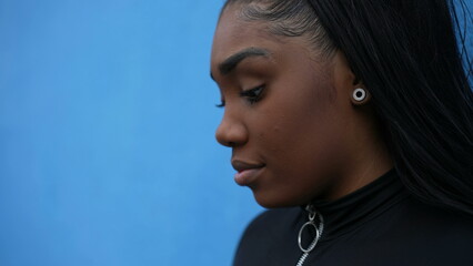 A pensive black girl a thoughtful African woman thinking about life standing outside