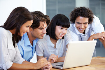 Brainstorming - Business Teams. A group of young entrepreneurs having a business meeting over a laptop.
