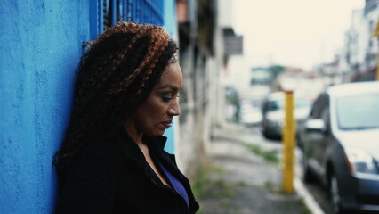 A desperate African woman outside in street feeling anxious
