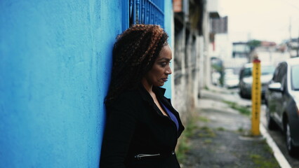 Fototapeta premium A desperate African woman outside in street feeling anxious