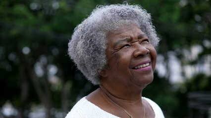 A contemplative black senior woman closing eyes in meditation