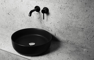 Photo of bathroom details: black matte sink and wall mounted basin tap.