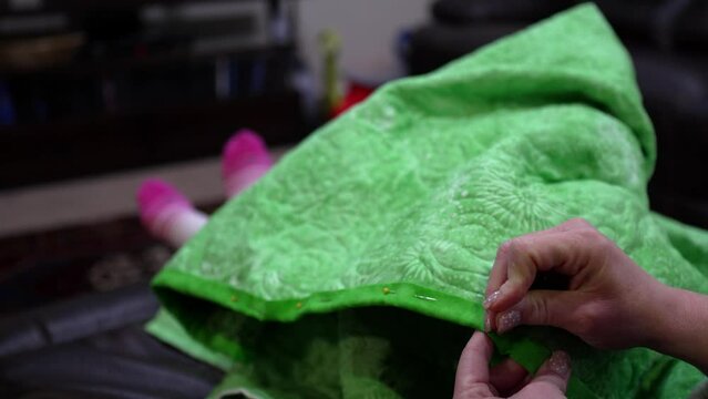 Hand stitching the binding on a quilt as the last step - isolated