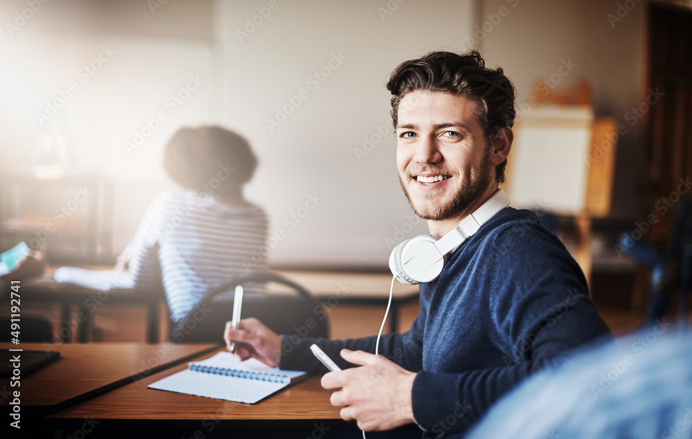 Poster eager to be learning and earning a tertiary education. cropped shot of university students in class.