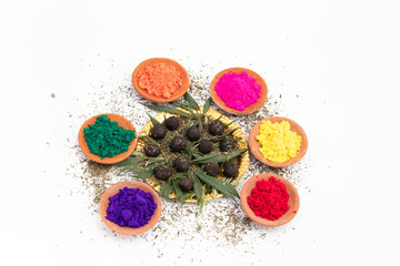 Obraz na płótnie Canvas Bhaang Ki Goli Or Bhang Ka Gola Is Made Of Is Herbal Edible Balls Made Of Cannabis Leaves Paste And Is Consumed Specially On Indian Festival Holi For Fun. Color Powder In Terracotta Bowls