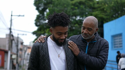 A African father congratulating adult son for achievement dad and son relationship