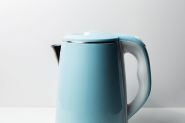Close-up of blue electric kettle on grey background.