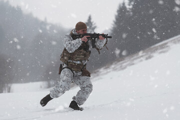 Fototapeta na wymiar Soldier in winter camouflaged uniform in Modern warfare army on a snow day on forest battlefield with a rifle. Model face very similar to Ukraine prime minister.