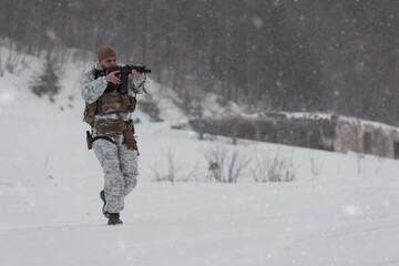 Fototapeta na wymiar Soldier in winter camouflaged uniform in Modern warfare army on a snow day on forest battlefield with a rifle. Model face very similar to Ukraine prime minister.