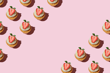 Pattern made of home cookies with strawberries and cream on a pink background. copy space for text, Repeating  homemade cookies with strawberries and cream pattern. Flat lay style.