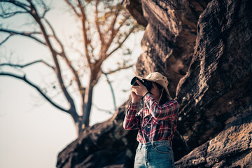 Happy young woman photographer travels.