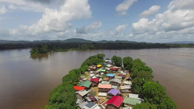 Aerial drone footage flying over unique remote island village in the Amazon South America.