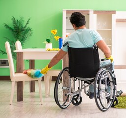 Obraz premium Disabled man on wheelchair cleaning house