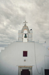 Fototapeta na wymiar Cross and bell of a greek church agios