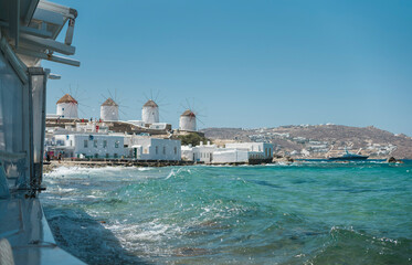 Sightings of Mykonos Island in Greece are of vivid whitewashed houses with vibrant blue doors and window frames, intensely colourful bougainvillaea glorious sunshine framed by the dazzling Aegean Sea