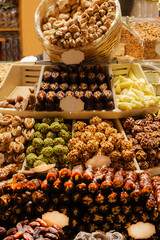 Traditional Turkish delicacies, nuts, dried fruits and desserts in Istanbul Spice Bazaar or Grand bazaar. dates, walnuts, pistachios, walnut pulp