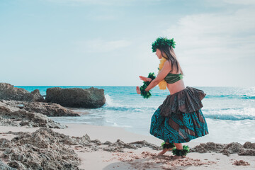 Hawaiian woman smiles relaxed on a paradise beach. Exotic beauty with flower crown on her head.