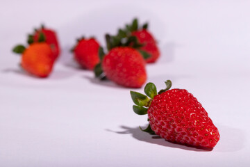 Red strawberry close-up photograph with defocused strawberries in the background.